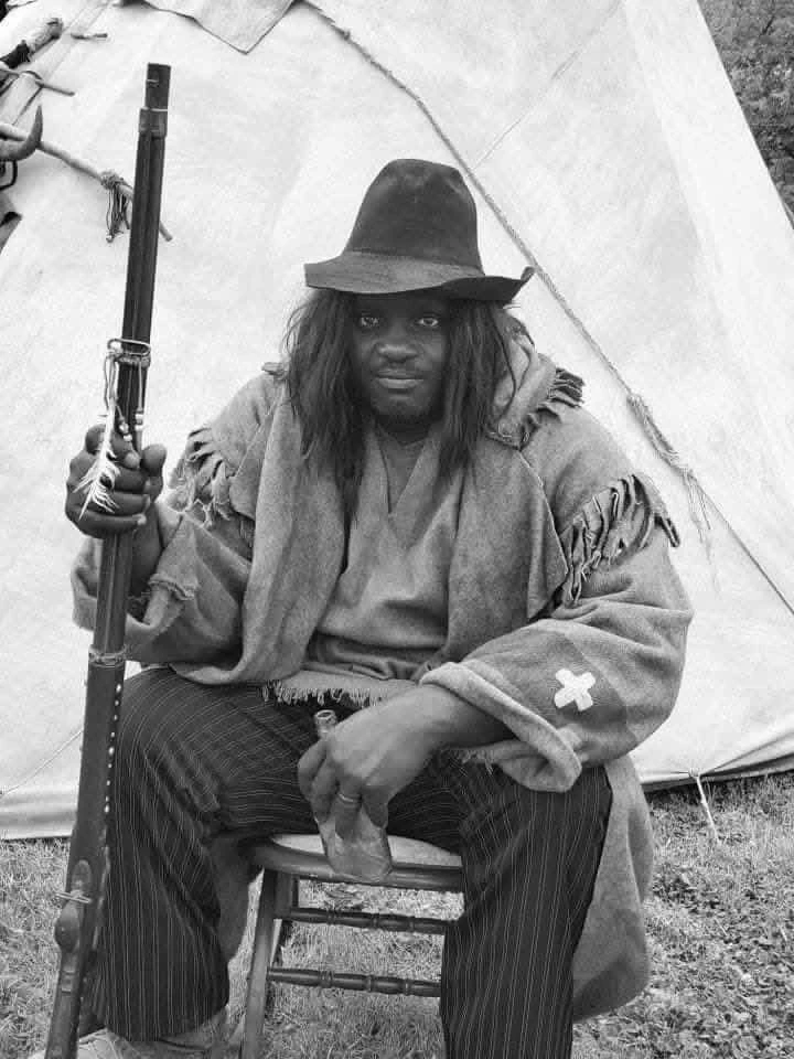 After photo: Black man in a Warpony Productions military-style costume during an educational library visit